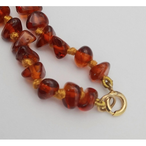 497 - Vintage AMBER NECKLACE with 9 CARAT GOLD CLASP.Consisting various shapes of polished  Amber individu... 