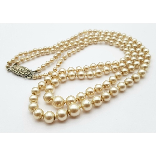 567 - Nice quality PEARL NECKLACE consisting two rows of graduated PEARLS individually knotted and closing... 