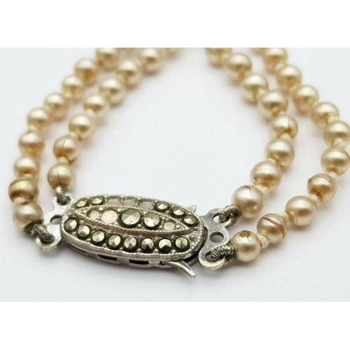 567 - Nice quality PEARL NECKLACE consisting two rows of graduated PEARLS individually knotted and closing... 