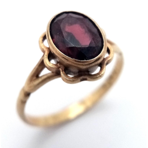 70 - Vintage 9 carat GOLD RING with large (1 carat) Oval Cut GARNET mounted to top. Complete with ring bo... 