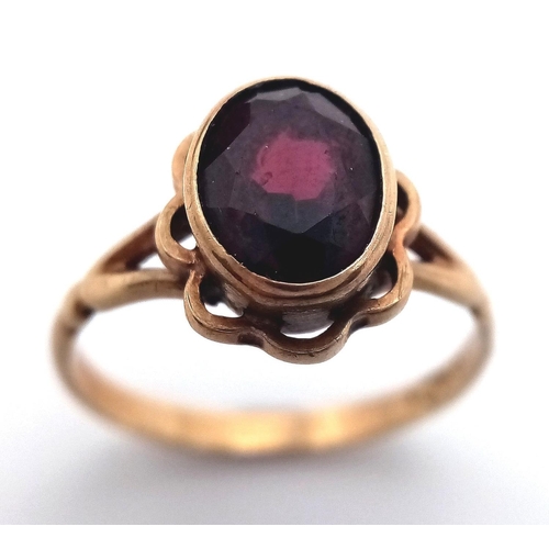 70 - Vintage 9 carat GOLD RING with large (1 carat) Oval Cut GARNET mounted to top. Complete with ring bo... 