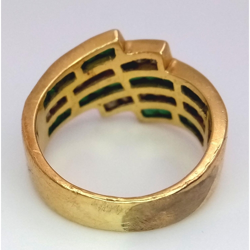 85 - An 18K Yellow Gold Emerald and Diamond Swirl Ring. 0.6ctw emeralds, 0.5ctw diamonds approx. Size K. ... 