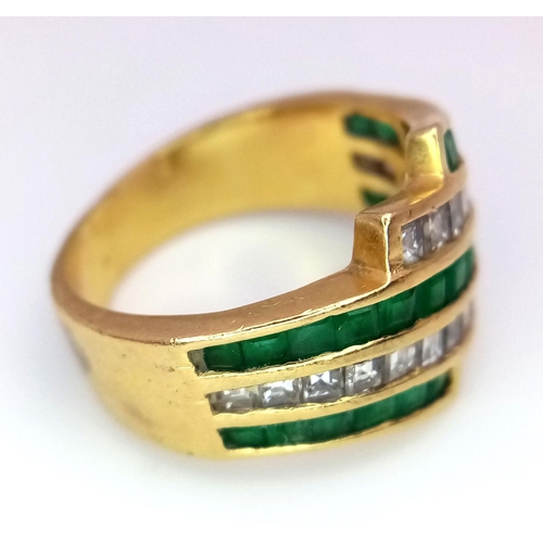 85 - An 18K Yellow Gold Emerald and Diamond Swirl Ring. 0.6ctw emeralds, 0.5ctw diamonds approx. Size K. ... 