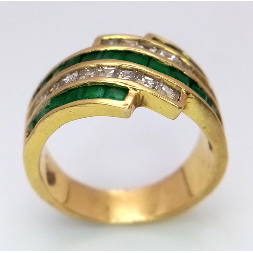 85 - An 18K Yellow Gold Emerald and Diamond Swirl Ring. 0.6ctw emeralds, 0.5ctw diamonds approx. Size K. ... 