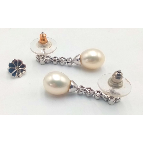 204 - A Pair of 18K White Gold, Diamond and Pearl Drop Earrings. 3cm. 6g total weight. Ref: 017609