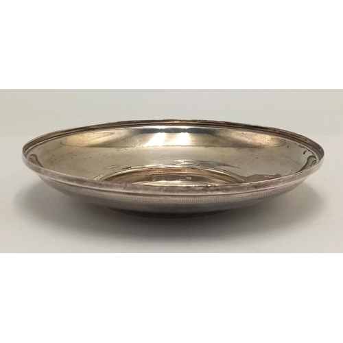 282 - A SILVER DISH INSCRIBED TO RONALD HARDMAN FROM HIS GODMOTHER IN AUGUST1899 .   47.4gms    9.5cms DIA... 