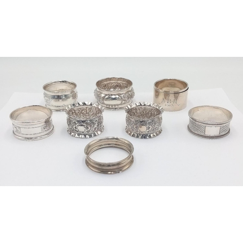 289 - A SELECTION OF 8 HALLMARKED SILVER NAPKIN RINGS ALL IN GOOD CONDITION .124 8gms