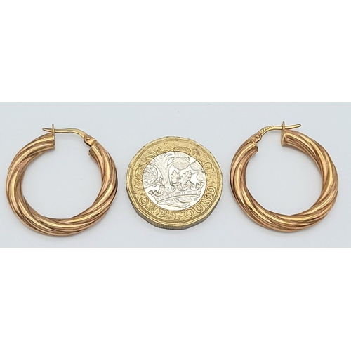 337 - A PAIR OF 9K GOLD TWIST HOOP EARRINGS .   1.8gms