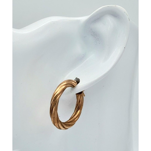 337 - A PAIR OF 9K GOLD TWIST HOOP EARRINGS .   1.8gms