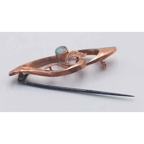 372 - AN ANTIQUE 14K ROSE GOLD  BROOCH WITH A SMALL FIRE OPEL.   1.5gms