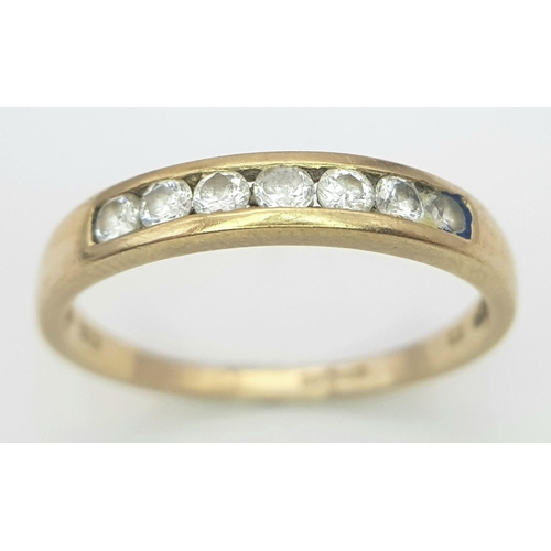 379 - A 9K GOLD RING WITH 7 CZ STONES CHANNEL SET IN IT.    1.6gms   size P