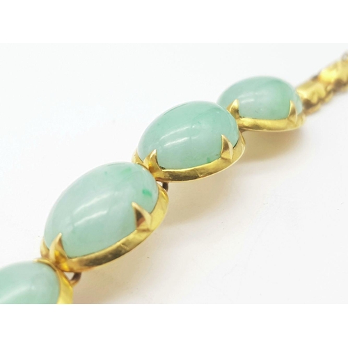 78 - A Child's 18K Yellow Gold (tested) and Jade Cabochon Bracelet. 14cm. 14g total weight.