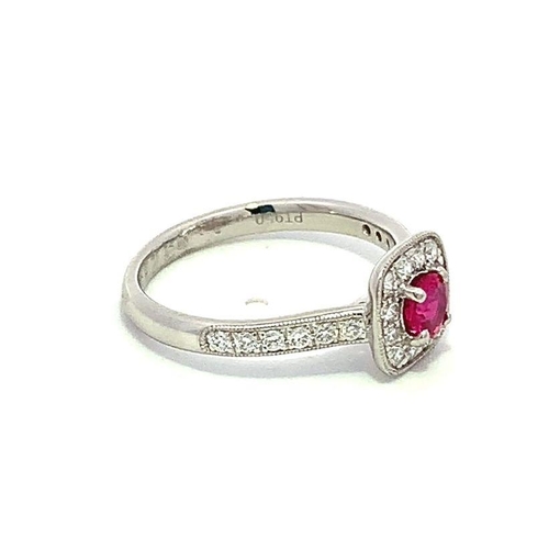 526 - Platinum RUBY and DIAMOND ring, set with 0.32ct claw set round Ruby centre, and 0.33ct halo surround... 