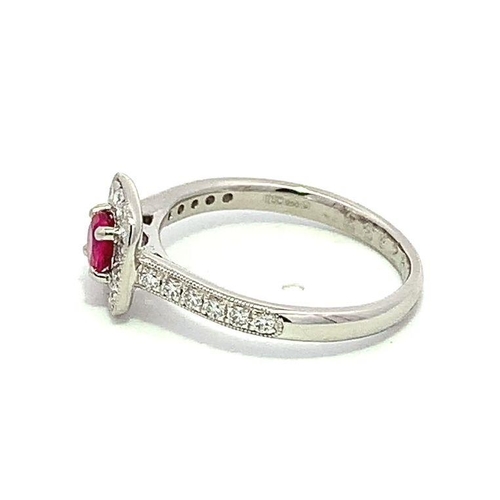 526 - Platinum RUBY and DIAMOND ring, set with 0.32ct claw set round Ruby centre, and 0.33ct halo surround... 