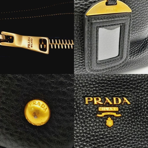 127 - A Prada Black Vitello Daino Tote Bag. Grained black leather exterior, gold-tone hardware, two rounde... 