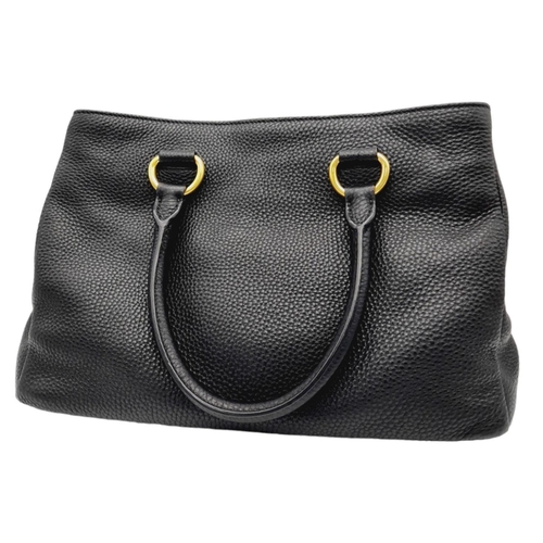 127 - A Prada Black Vitello Daino Tote Bag. Grained black leather exterior, gold-tone hardware, two rounde... 