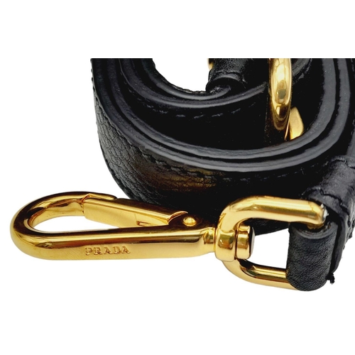 127 - A Prada Black Vitello Daino Tote Bag. Grained black leather exterior, gold-tone hardware, two rounde... 