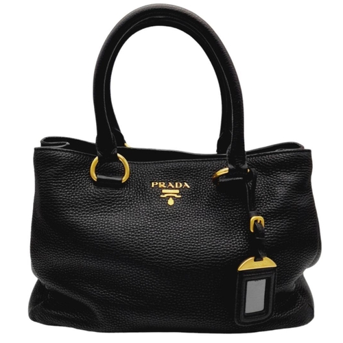 127 - A Prada Black Vitello Daino Tote Bag. Grained black leather exterior, gold-tone hardware, two rounde... 