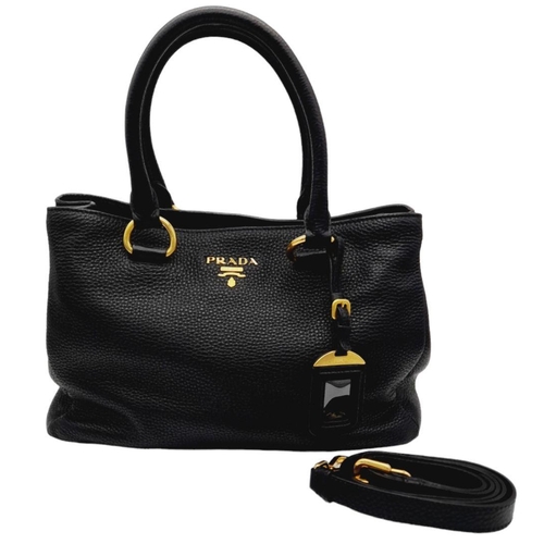 127 - A Prada Black Vitello Daino Tote Bag. Grained black leather exterior, gold-tone hardware, two rounde... 