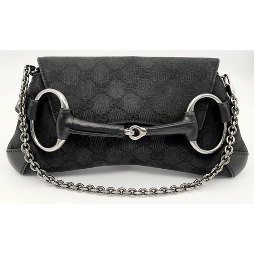 141 - A Gucci Black Monogram Horsebit Chain Clutch Bag. Classic Monogram GG Canvas with Black Leather Trim... 