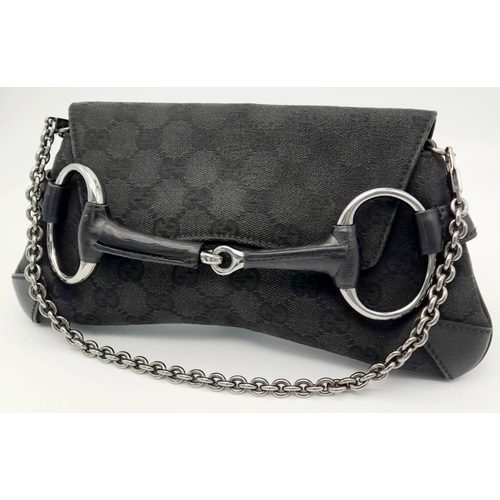 141 - A Gucci Black Monogram Horsebit Chain Clutch Bag. Classic Monogram GG Canvas with Black Leather Trim... 