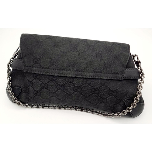 141 - A Gucci Black Monogram Horsebit Chain Clutch Bag. Classic Monogram GG Canvas with Black Leather Trim... 