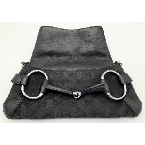 141 - A Gucci Black Monogram Horsebit Chain Clutch Bag. Classic Monogram GG Canvas with Black Leather Trim... 