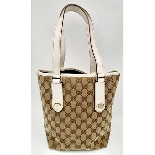 134 - A Gucci Beige/Brown Charmy GG Monogrammed Tote Bag. Canvas exterior with leather trim, flat leather ... 