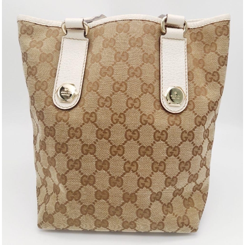 134 - A Gucci Beige/Brown Charmy GG Monogrammed Tote Bag. Canvas exterior with leather trim, flat leather ... 