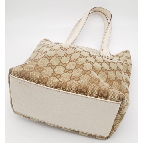 134 - A Gucci Beige/Brown Charmy GG Monogrammed Tote Bag. Canvas exterior with leather trim, flat leather ... 