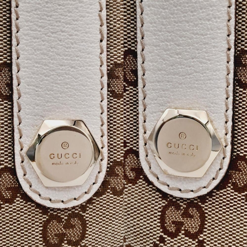 134 - A Gucci Beige/Brown Charmy GG Monogrammed Tote Bag. Canvas exterior with leather trim, flat leather ... 