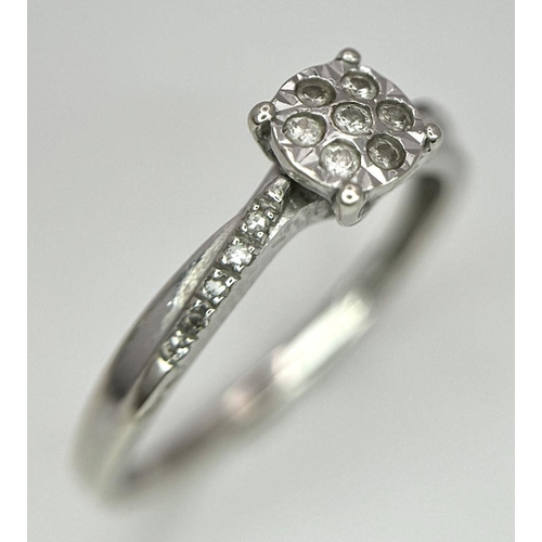 523 - A 9K WHITE GOLD DIAMOND CROSS-OVER CLUSTER RING 1.5G , SIZE K.

ref: SC 2004