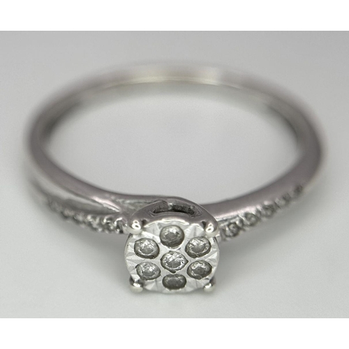 523 - A 9K WHITE GOLD DIAMOND CROSS-OVER CLUSTER RING 1.5G , SIZE K.

ref: SC 2004