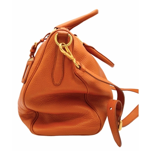 113 - A Prada Orange Vitello Daino Satchel Bag. Leather exterior, gold-tone hardware, double rolled leathe... 