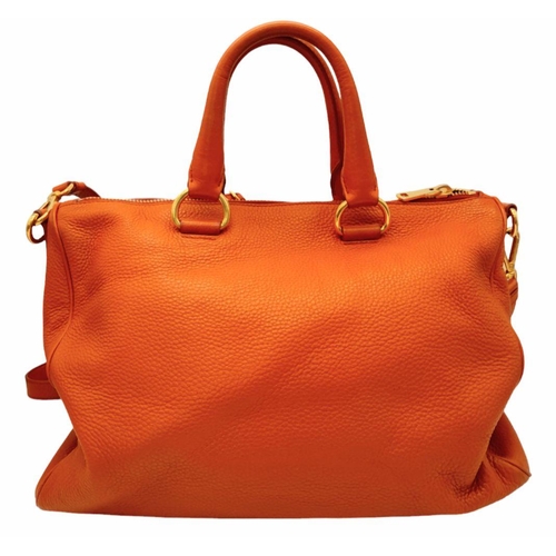 113 - A Prada Orange Vitello Daino Satchel Bag. Leather exterior, gold-tone hardware, double rolled leathe... 