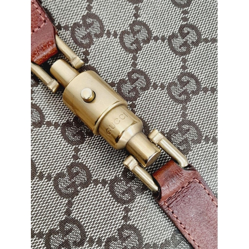 218 - A Gucci Monogram Jackie O Hobo Shoulder Bag. Gucci GG Monogram Canvas exterior, brown leather at the... 