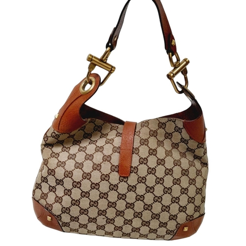 218 - A Gucci Monogram Jackie O Hobo Shoulder Bag. Gucci GG Monogram Canvas exterior, brown leather at the... 