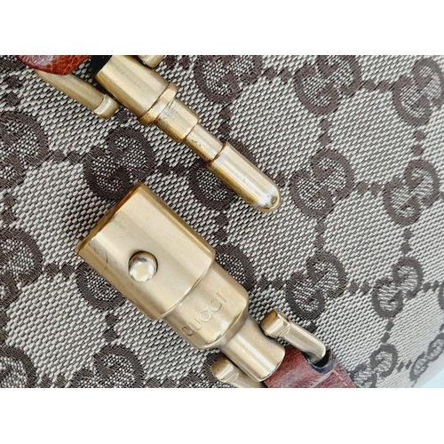 218 - A Gucci Monogram Jackie O Hobo Shoulder Bag. Gucci GG Monogram Canvas exterior, brown leather at the... 