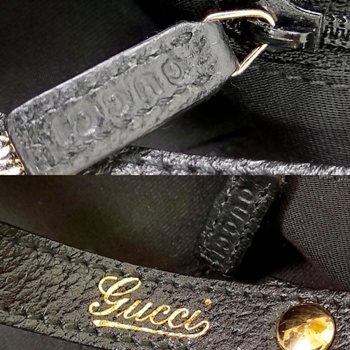 232 - A Gucci Monogram Abbey Shoulder Bag. Black Gucci GG Monogram Canvas Exterior, leather straps, silver... 