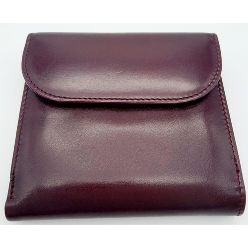 239 - A Launer Burgundy Wallet. Leather exterior, gold-tone metal clasp that open to reveal six card slots... 