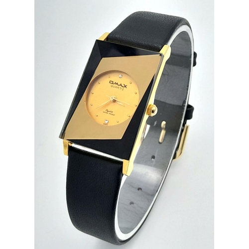 1351 - An Omax Quartz Ladies Watch. Black leather strap. Rectangular gilded case - 23mm. Gilded dial. In wo... 