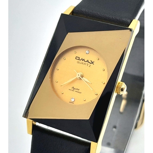 1351 - An Omax Quartz Ladies Watch. Black leather strap. Rectangular gilded case - 23mm. Gilded dial. In wo... 