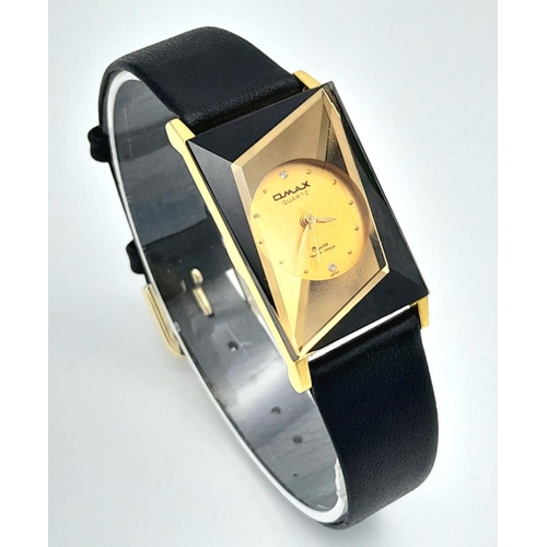 1351 - An Omax Quartz Ladies Watch. Black leather strap. Rectangular gilded case - 23mm. Gilded dial. In wo... 