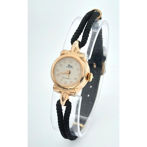 1358 - A Vintage Disu Mechanical 15 Jewels Ladies Watch. Textile strap. Gilded case - 19mm. White dial in w... 