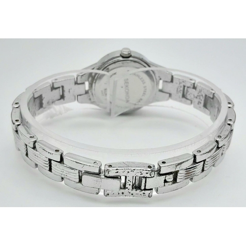 1365 - A Ladies Stone Set Quartz Sekonda Watch. Stainless steel bracelet and case - 24mm. White dial. In wo... 