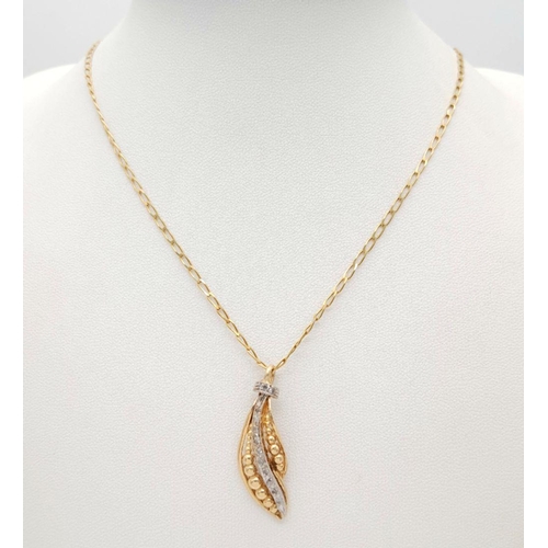 239 - An 18K Gold Necklace with a Hanging Leaf Form Pendant - A Line of Diamonds Separating Graduated Gold... 