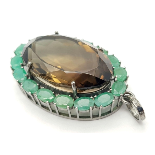 242 - A Smoky Quartz and Emerald Pendant. Oval cut 50ct smoky quartz with a 7.5ct Emerald surround. Set in... 