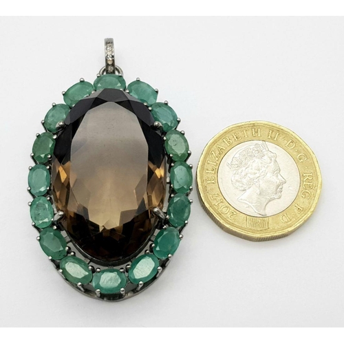 242 - A Smoky Quartz and Emerald Pendant. Oval cut 50ct smoky quartz with a 7.5ct Emerald surround. Set in... 