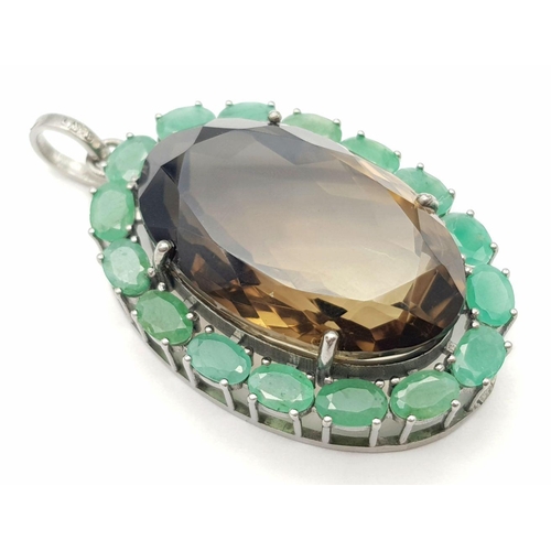 242 - A Smoky Quartz and Emerald Pendant. Oval cut 50ct smoky quartz with a 7.5ct Emerald surround. Set in... 