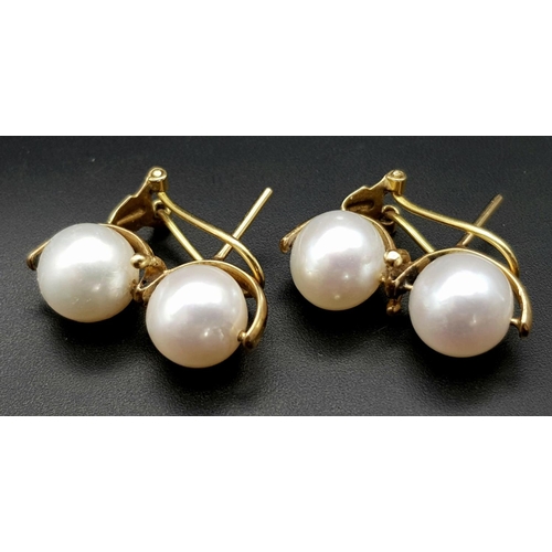 246 - A Pair of 18K Yellow Gold Twin South Sea Pearl Earrings. Clip design. 10mm pearls. 9g total weight.